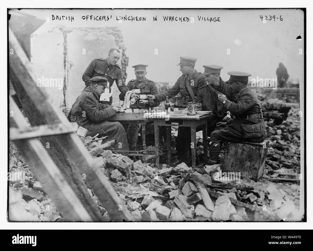 Britische Offiziere Mittagessen im zerstörten Dorf Stockfoto