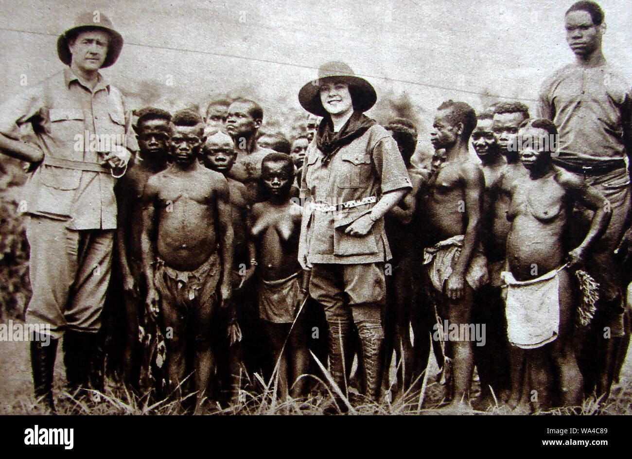1934 American Explorers mit einem pygmy Stamm in der Afrikanischen Kongobecken. Die wichtigsten Stämme in der Region waren die Bambenga, Bambuti Mbenga (Aka und Baka) und Batwa Stockfoto