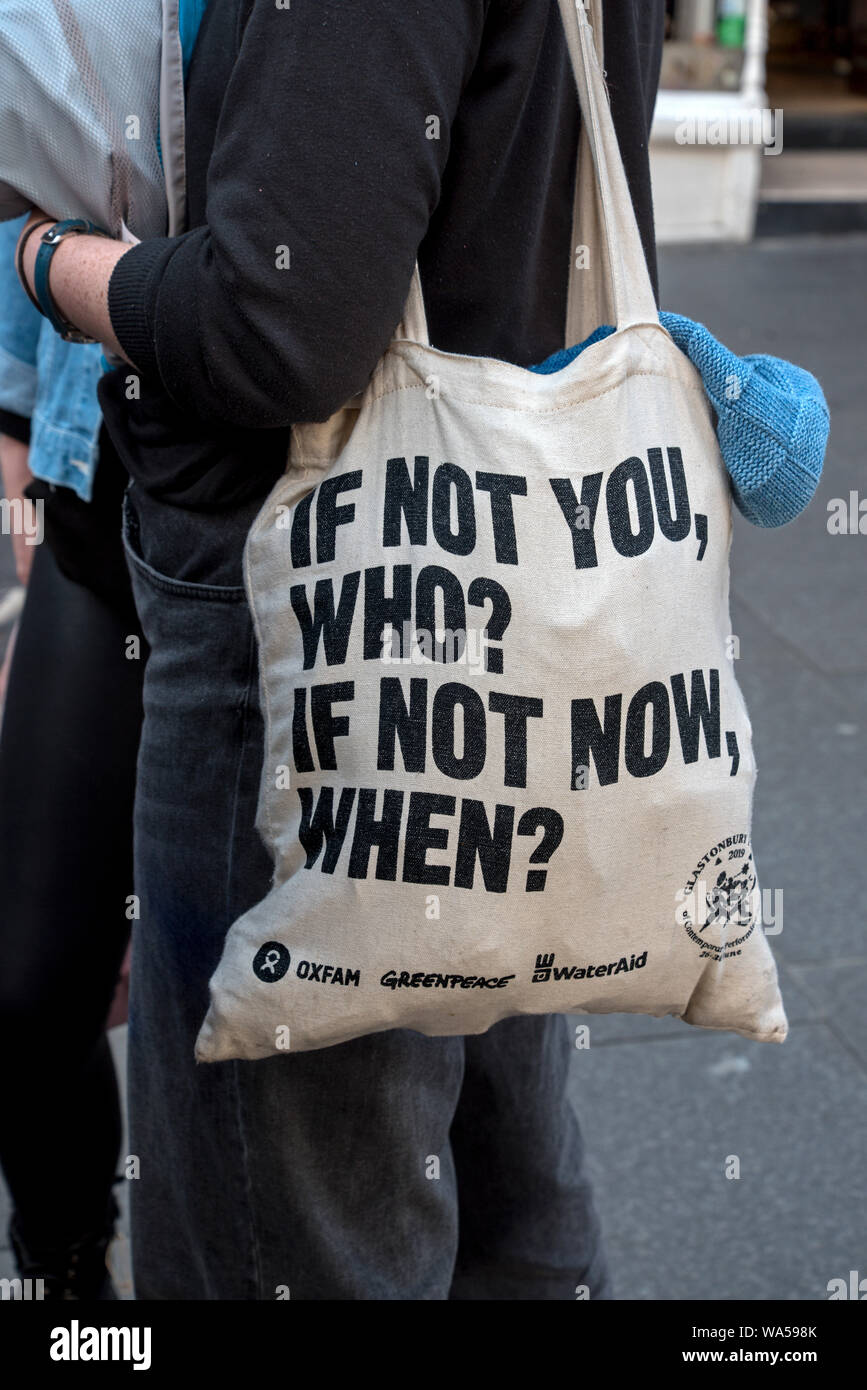 Junge Frau, die eine Tasche mit dem Wort tote - Wenn nicht Du, wer? Wenn Nicht Jetzt, Wann Dann? Stockfoto
