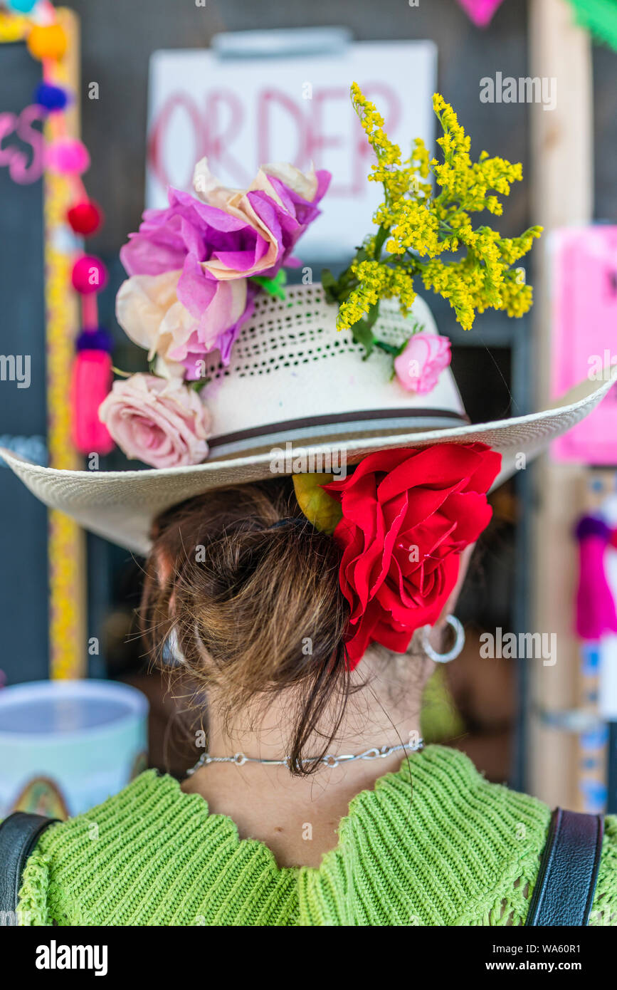 30-40 Jahre alten weiblichen Erwachsenen verschleißt sehr bunte Kleidung für eine Fiesta in Santa Barbara, Kalifornien, während Sie in einem Lebensmittel Leitung wartet. Stockfoto