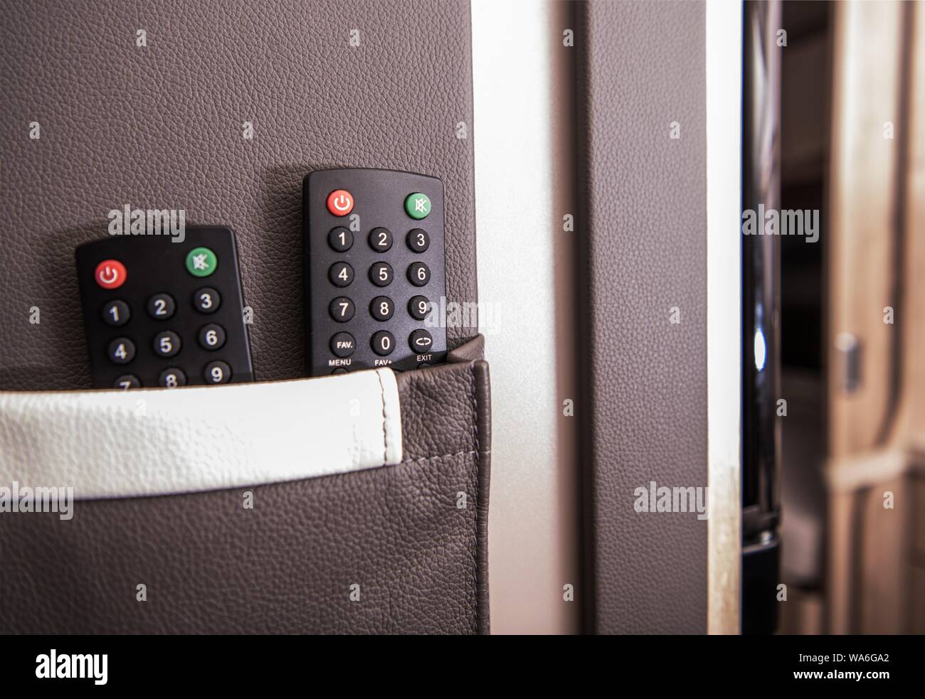 Camper Multimedia-systeme. Zwei Fernbedienungen im Travel Trailer hängende Tasche. Fernsehen und Radio im Wohnwagen. Freizeit und Tourismus Die Stockfoto