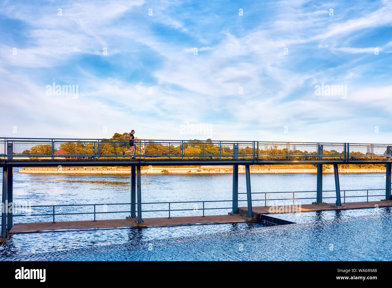 Frau Joggen auf der Brücke über den Sankt-Lorenz-Strom in Montreal, Quebec, Kanada. Stockfoto