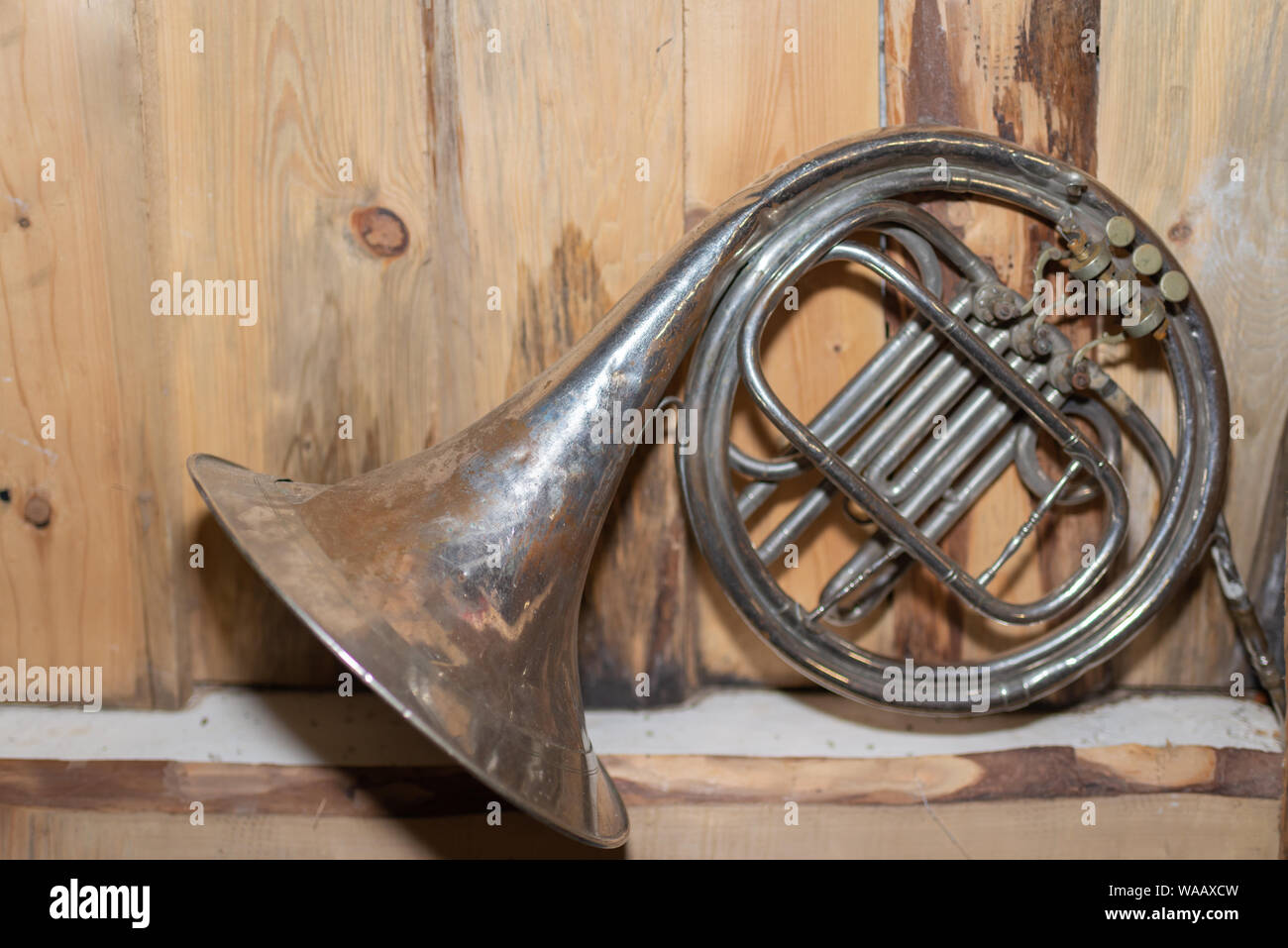 Alte Blasinstrument, Horn, vooden Hintergrund. Stockfoto