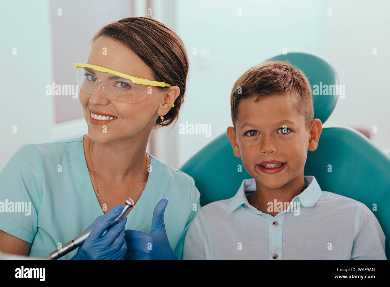 Süße Junge lächelnd während Zähne Prüfung. Happy Boy im Zahnarztstuhl sitzen und in Check up Zähne Stockfoto