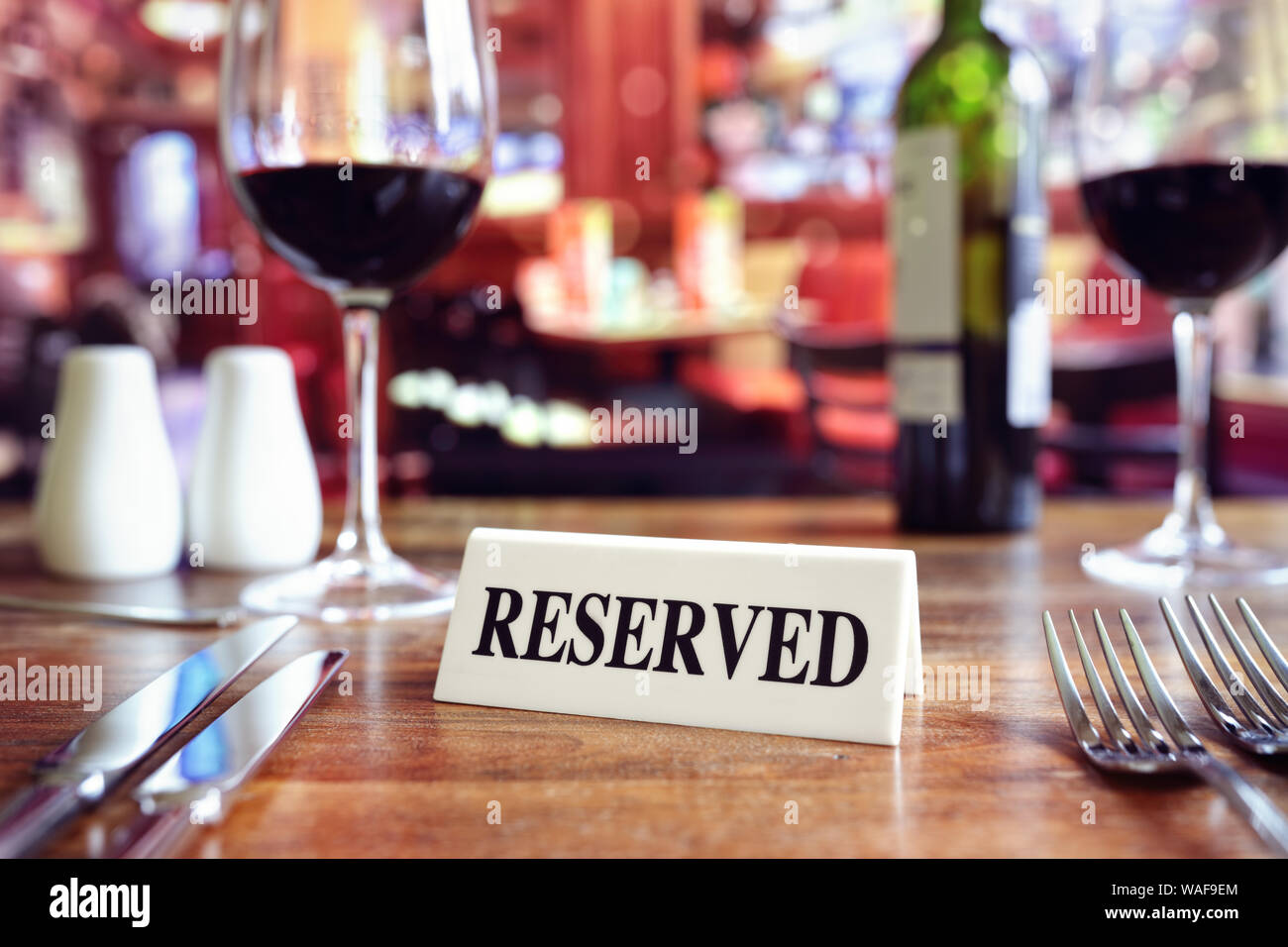 Restaurant Tisch reserviert Schild mit Orte Einstellung und Wein Gläser bereit für eine party Stockfoto