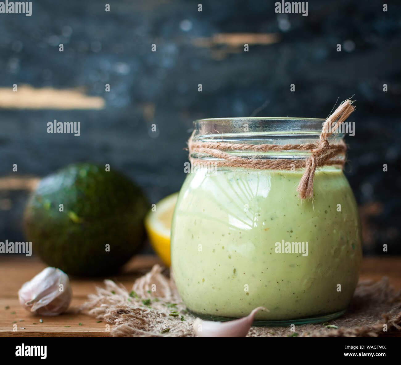 Nahaufnahme der hausgemachte Creme avocado Dressing in einem Glas auf Holz- Hintergrund Stockfoto