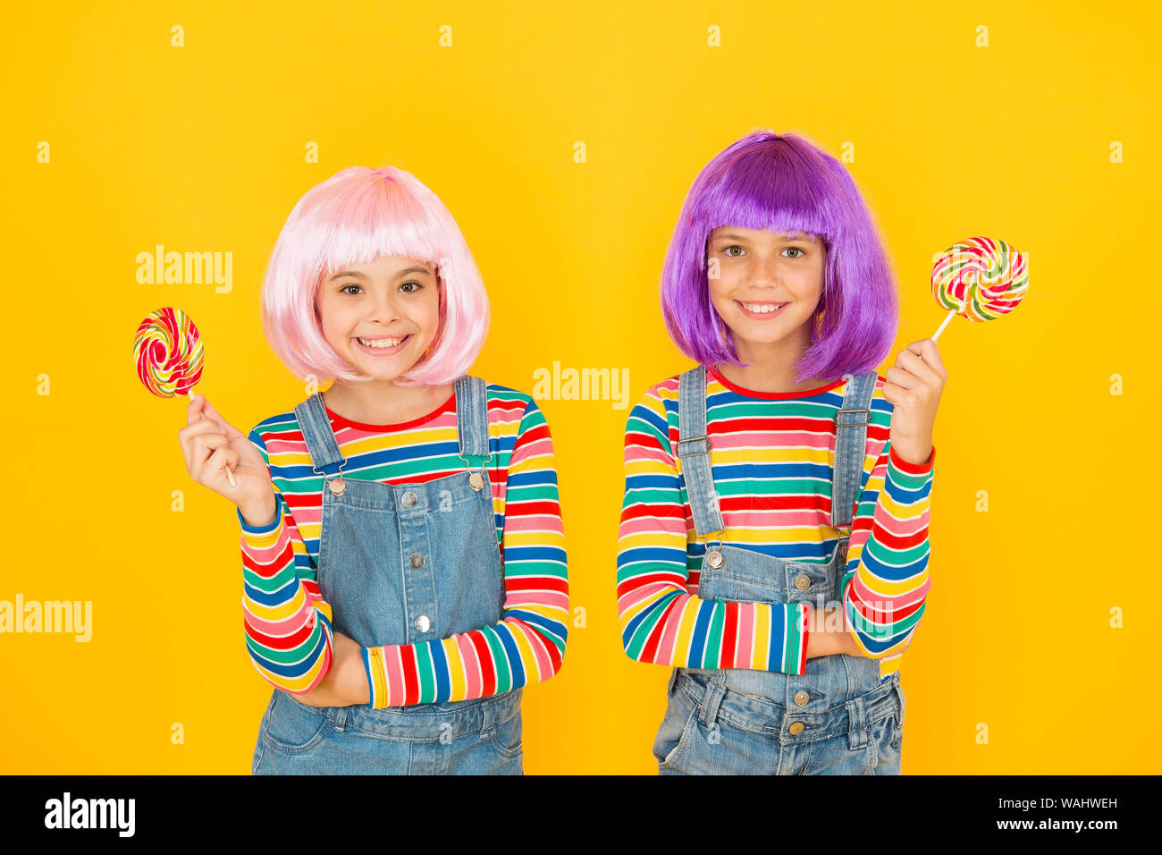 Anime Cosplay party Konzept. Gerne kleine Mädchen. Anime Fan. Kinder mit künstlichen Frisuren essen Lutscher. Anime Convention. Lebendige Zeichen phantastische Themen. Moderne Kindheit. Tag der Kinder. Stockfoto