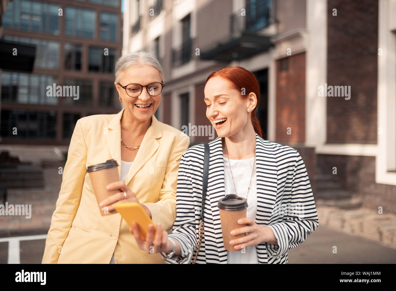 Zwei Business Damen Lachen, während sie Fotos suchen Stockfoto