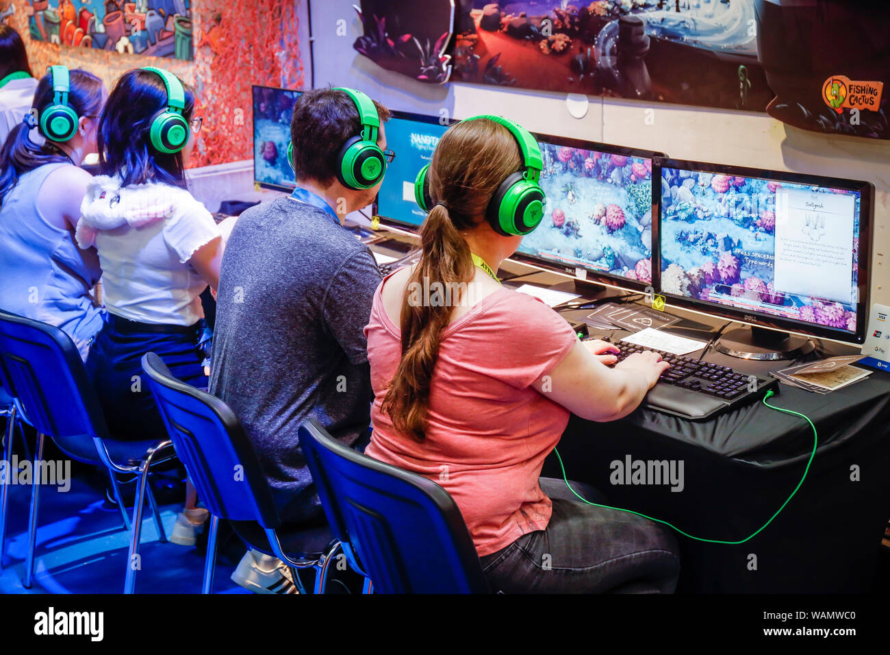 Köln, Nordrhein-Westfalen, Deutschland - Gamescom, junge Messe Besucher spielen Sie das Spiel durch die Fischerei Nanotale Kaktus auf der Gamescom fair. Koel Stockfoto