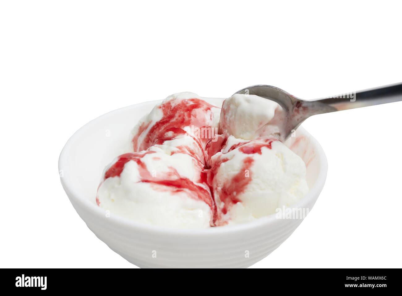 Kugeln aus weißem Eis mit roten Beeren Sirup in einer weißen Schüssel auf einem weißen Hintergrund. Eis Kommissionierung Löffel Stockfoto
