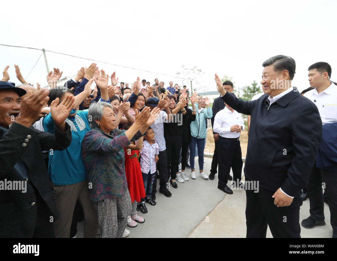 Wuwei, Provinz Gansu in China. 21 Aug, 2019. Der chinesische Präsident Xi Jinping, auch Generalsekretär der Kommunistischen Partei Chinas und Vorsitzender der Zentralen Militärkommission, besuche eine neue Gemeinschaft, die Heimat der ländlichen Bewohner aus ökologischen Bedenken verlegt, und fragt die Dorfbewohner über ihren Lebensunterhalt und die Fortschritte bei der Linderung von Armut, fumin neue Dorf Gulang County, Wuwei Stadt im Nordwesten der chinesischen Provinz Gansu, Aug 21., 2019. Credit: Ju Peng-/Xinhua/Alamy leben Nachrichten Stockfoto