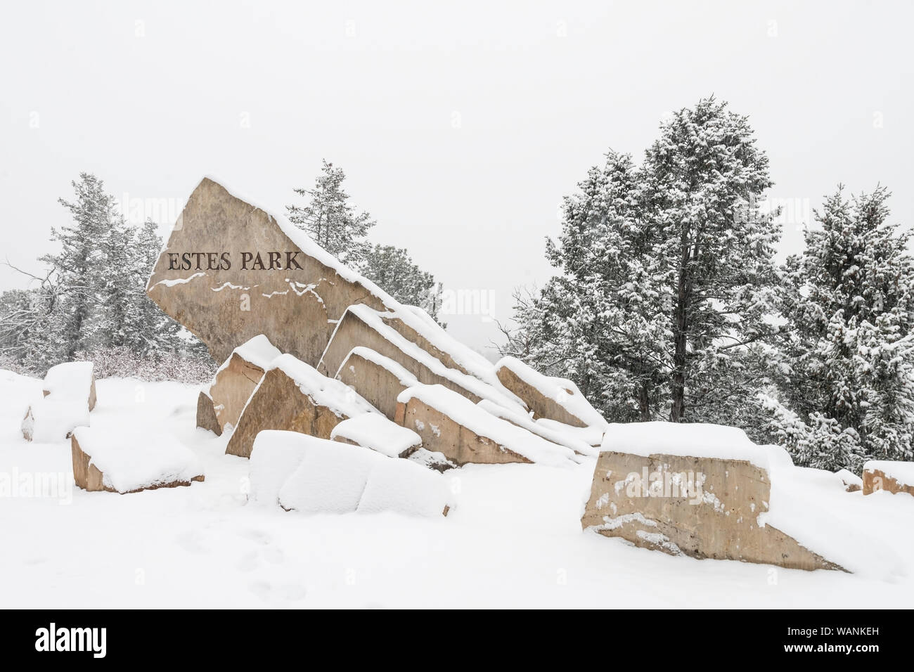 Die herzlich Willkommen Schild nach Estes Park am US-Highway 36 ist mit frischem Schnee bedeckt. Stockfoto