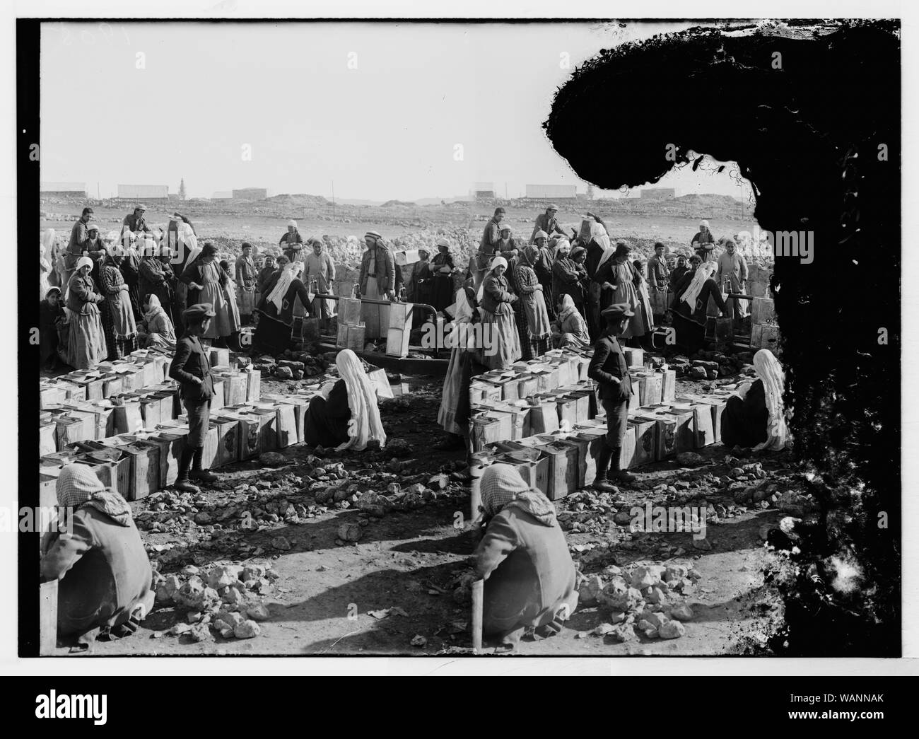 Masse von Männern und Frauen, die Wasser aus Zapfen, möglicherweise an der Jerusalem Wasserwerk in Ain Arroub Stockfoto