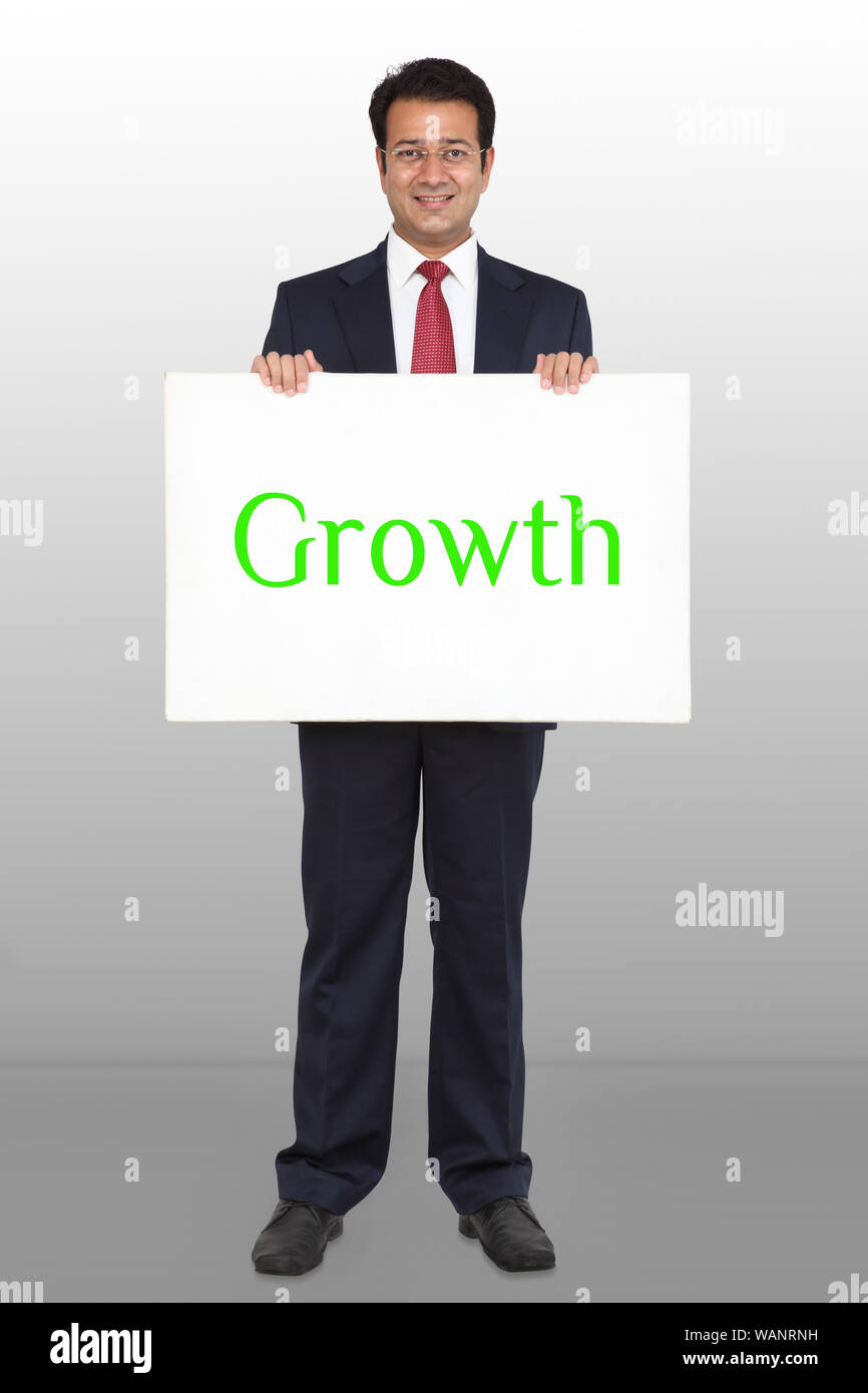 Geschäftsmann zeigt Plakat Wachstum darauf isoliert auf farbigem Hintergrund geschrieben Stockfoto