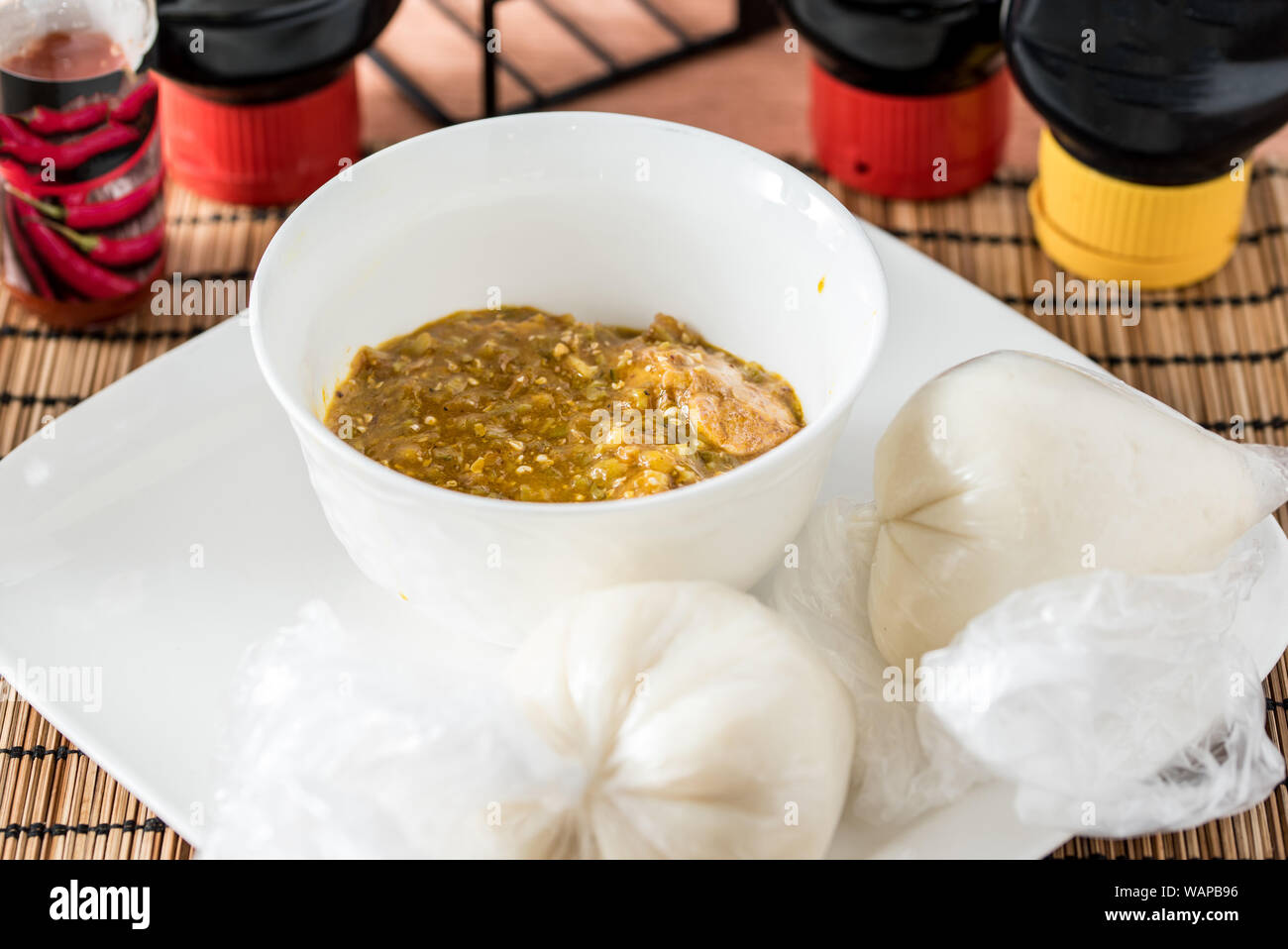 Regionale afrikanische Speisen auf weiße Platte auf hölzernen Hintergrund Stockfoto