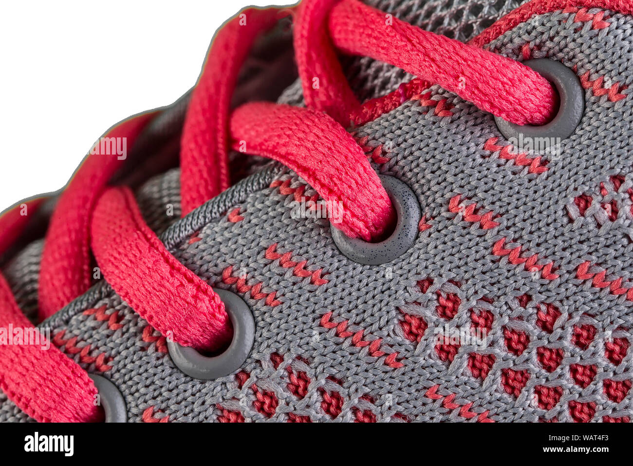 Ein Fragment eines grau Sneaker mit rosa Spitzen hautnah. Sneaker Textur Stockfoto