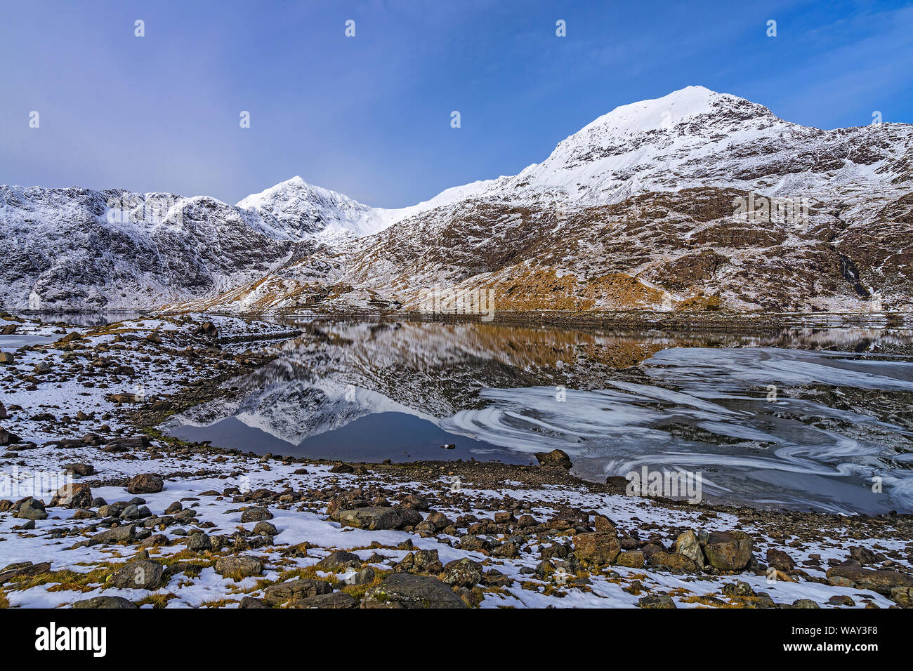 Blick über Llyn (See) Llydaw zeigen Floating ice Formationen mit Mount Snowdon und Krippe Goch Berg im Hintergrund Snowdonia National Park noch Stockfoto