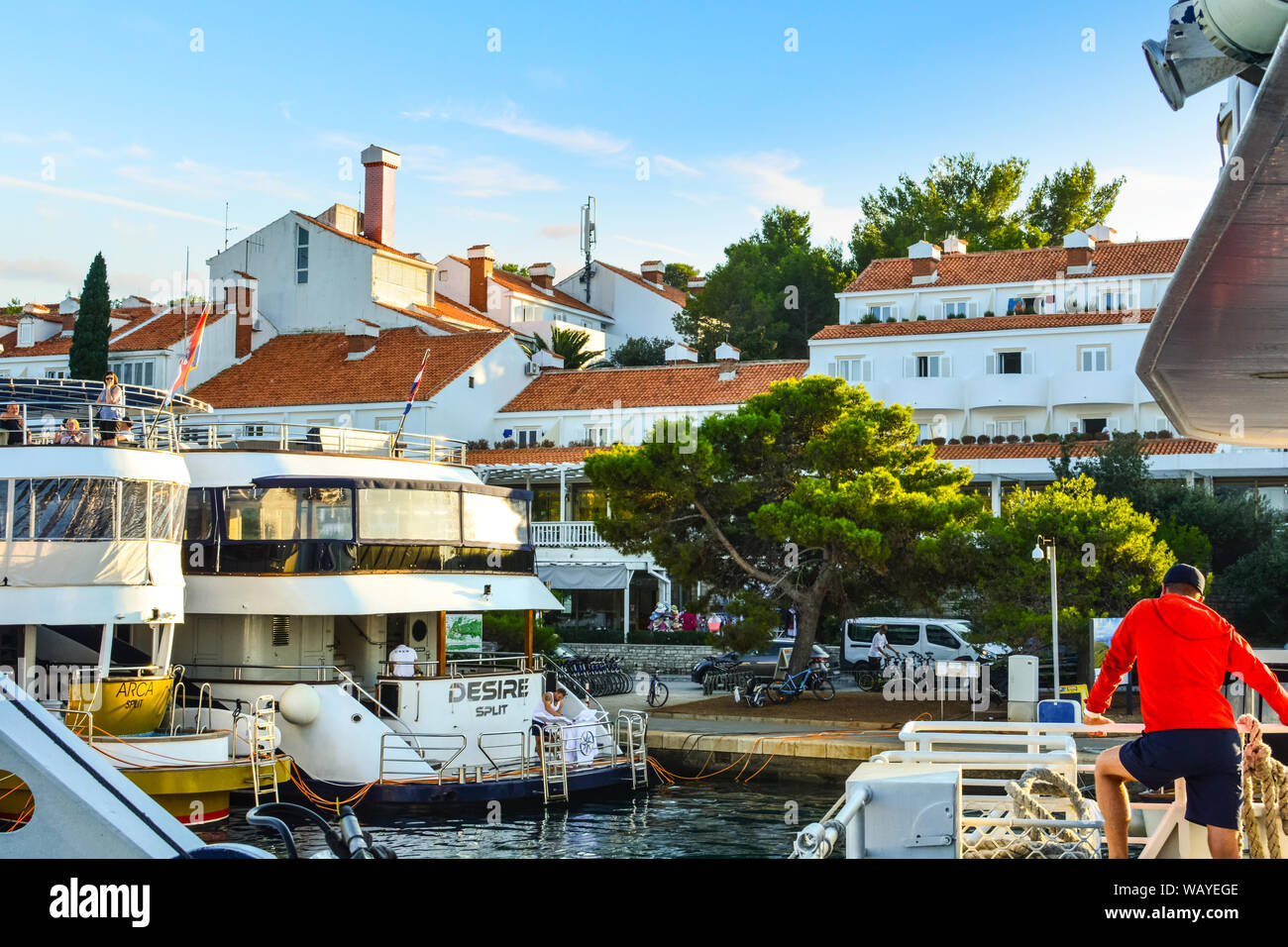 Eine yacht Kapitän Uhren als Tour Boote am Hafen von Dubrovnik, Kroatien am Ende des Sommer Saison. Stockfoto