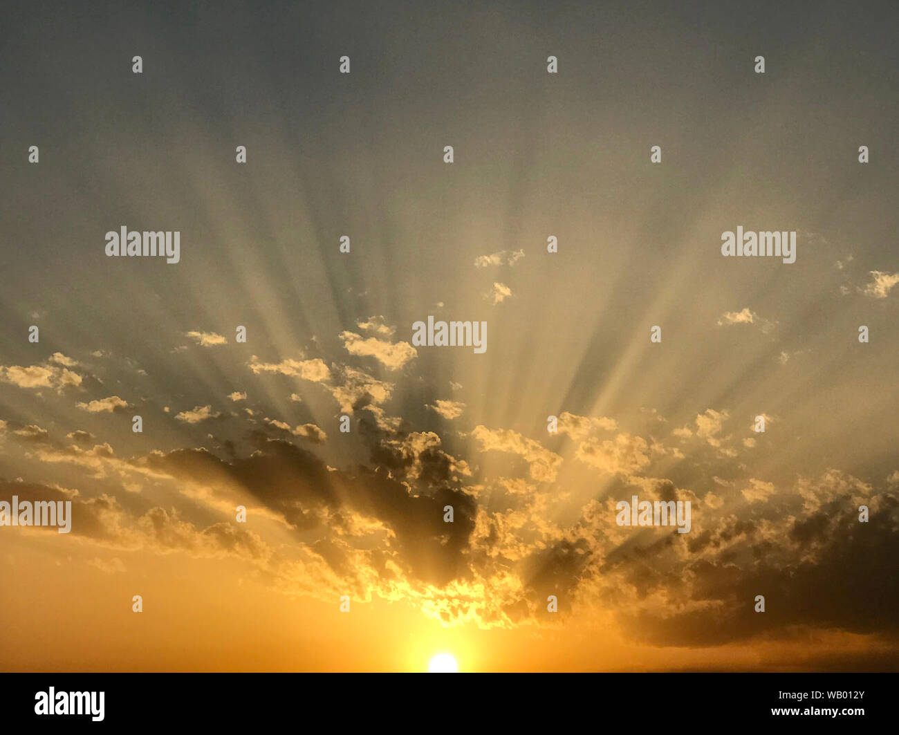 Sonnenuntergang mit Wolken und Sonnenstrahlen Stockfoto