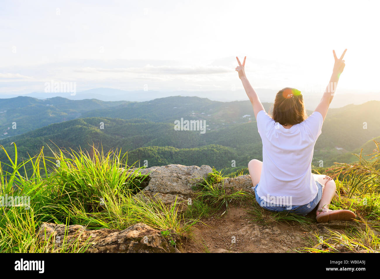 Zurück Seite junge Mädchen, zwei Finger auf der Flucht vor der Freiheit auf der Oberseite des Berges Stockfoto