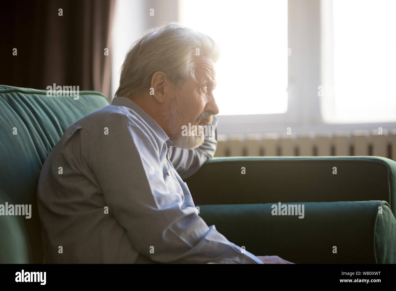 Nachdenklich senior Opa sitzen allein auf dem Sofa denken der Einsamkeit Stockfoto