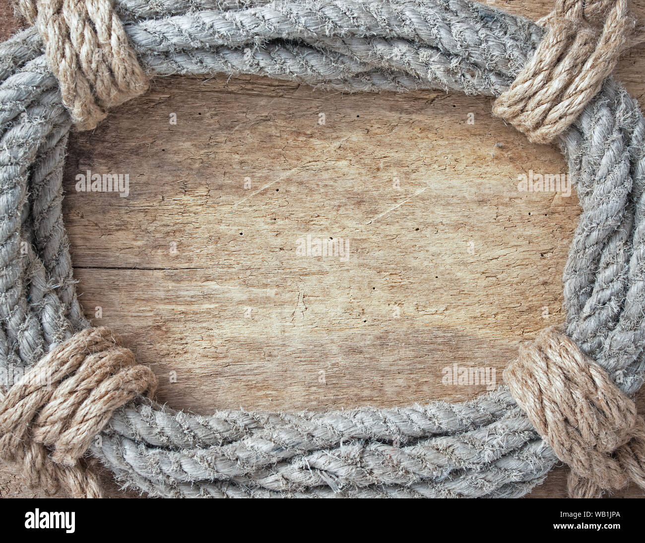 Rahmen aus verdrillten Seil auf einer hölzernen Hintergrund Stockfoto