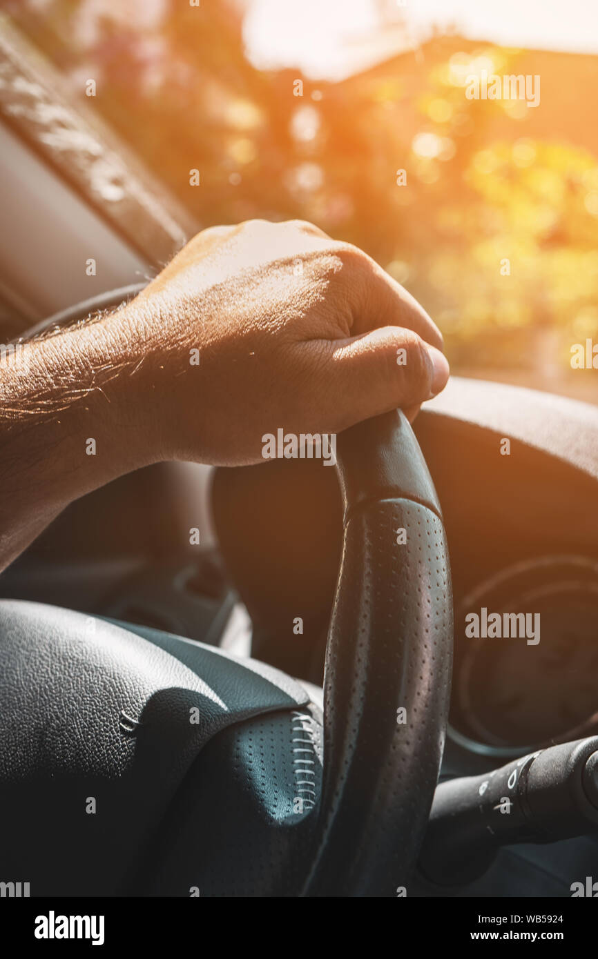 Aufnahme eines Mannes Hände halten ein Auto Lenkrad hautnah. Stockfoto