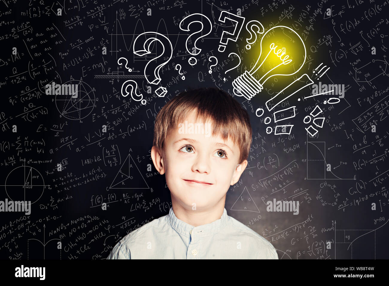 Schule Junge mit Glühbirne für den Hintergrund. Wissenschaft Idee Konzept mit Formeln Stockfoto