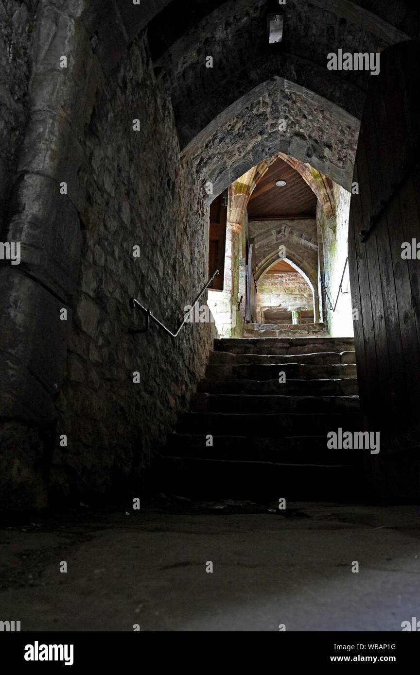 Eine dunkle und atmosphärische Treppe in Chepstow Castle, Wales. Stockfoto