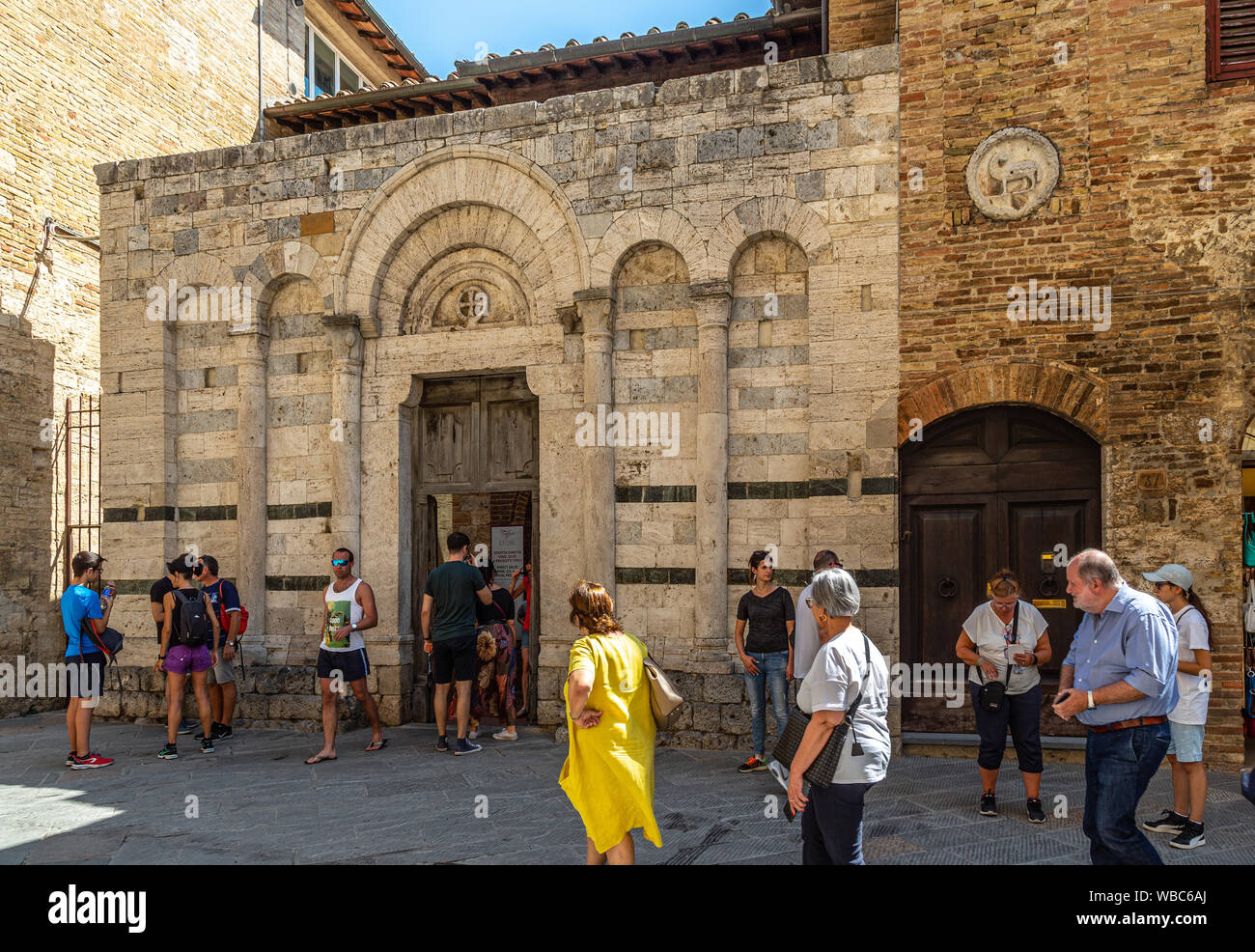 Touristen, die in der mittelalterlichen Kirche San Francesco, San Gimignano Stockfoto