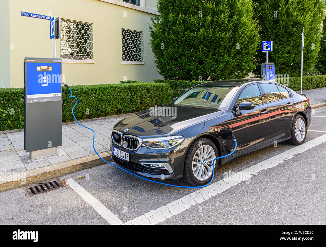 BMW 5er Plug-in-Hybrid an eine Ladestation in München, Deutschland  Stockfotografie - Alamy
