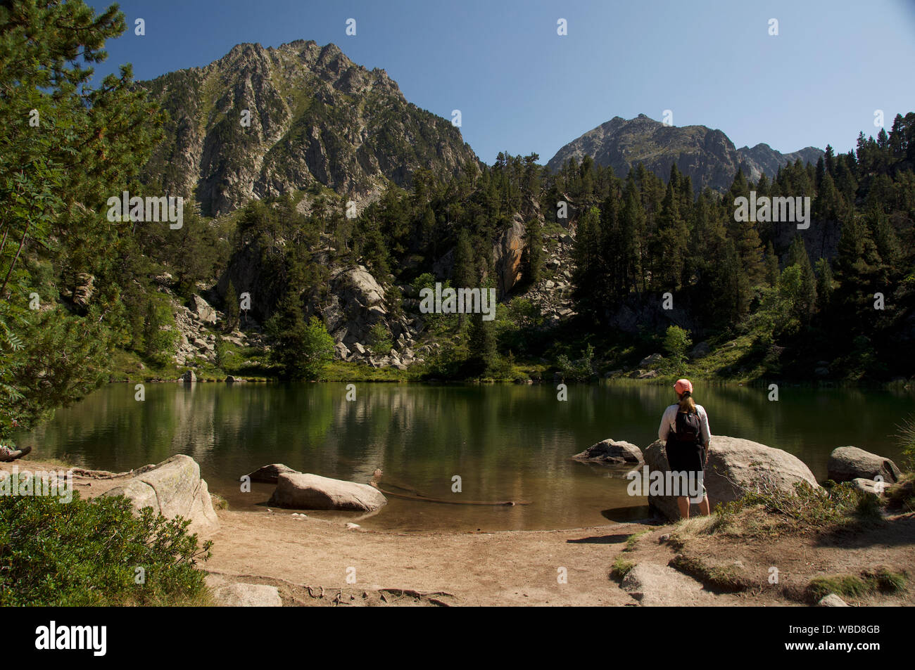Eine weibliche Wanderer betrachtet ein See im Gerber Tal, hohe Pyrenäen, Catalunya Stockfoto