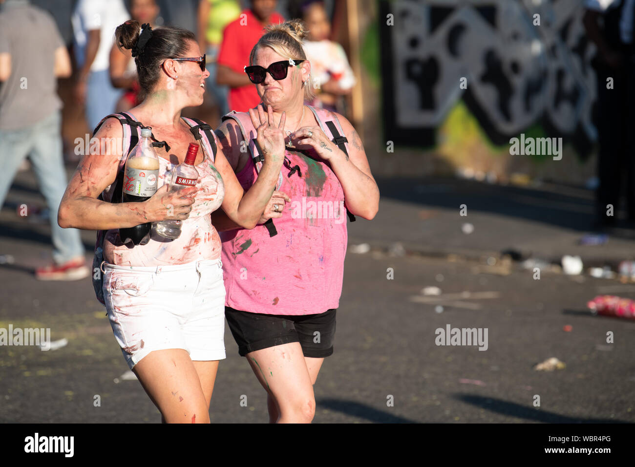 Eine Gruppe von Frauen ein Spaziergang durch Notting Hill Carnival in Farbe mit ihren Freunden. Stockfoto