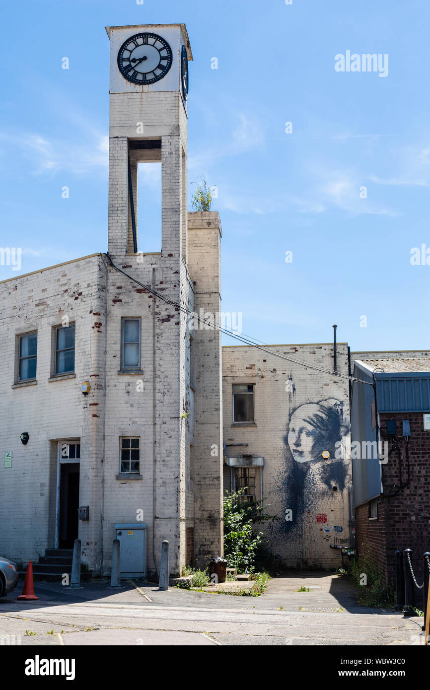 Ein banksy Wandmalerei, "Das Mädchen mit dem durchbohrten Trommelfell' auf ein Gebäude in Bristol, England Stockfoto