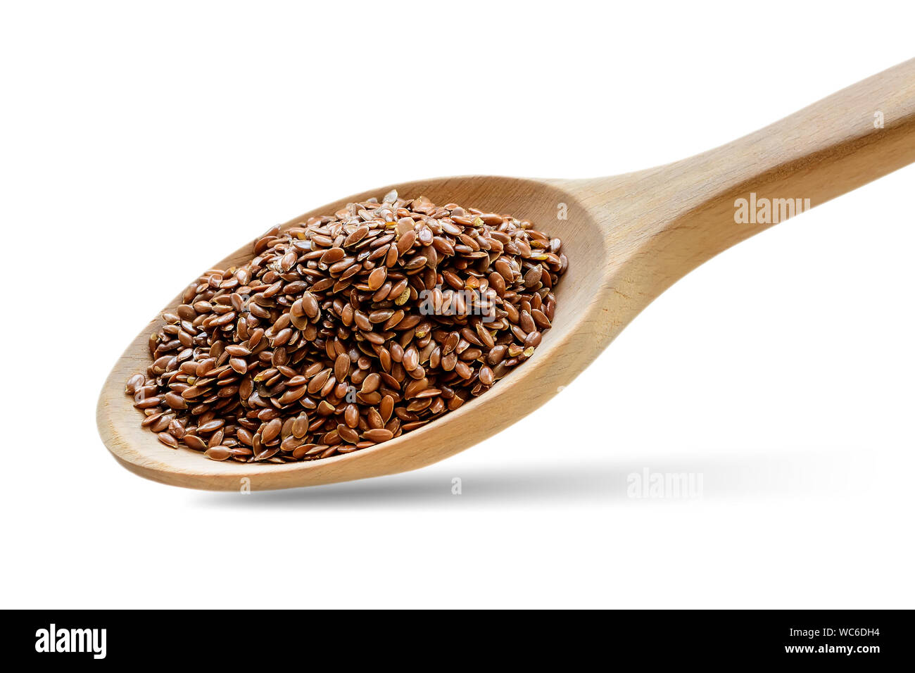 Ganze Leinsamen in einem Löffel aus Holz. Gesunde Lebensmittel für Cholesterin senken und Prävention von Herzkrankheiten und Krebs. Isklated auf weißem Hintergrund. Stockfoto