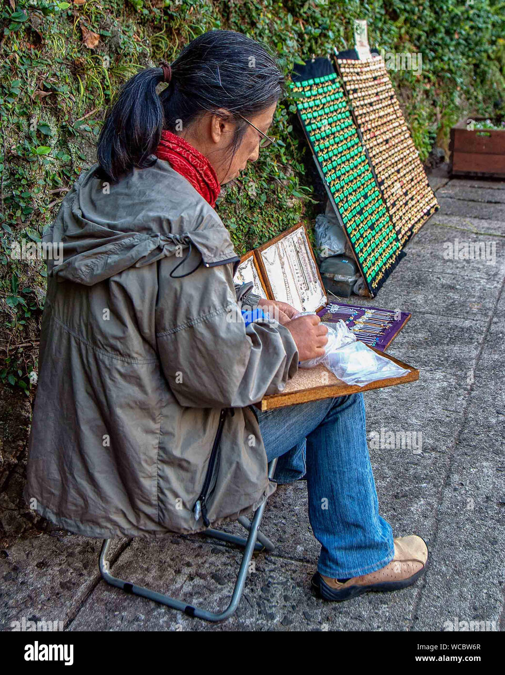 Nagasaki, Kyushu, Japan. 28 Okt, 2006. Design Schmuck, eine Japanische artisan sitzt neben ihrer Straße Anzeige in Nagasaki. Credit: Arnold Drapkin/ZUMA Draht/Alamy leben Nachrichten Stockfoto