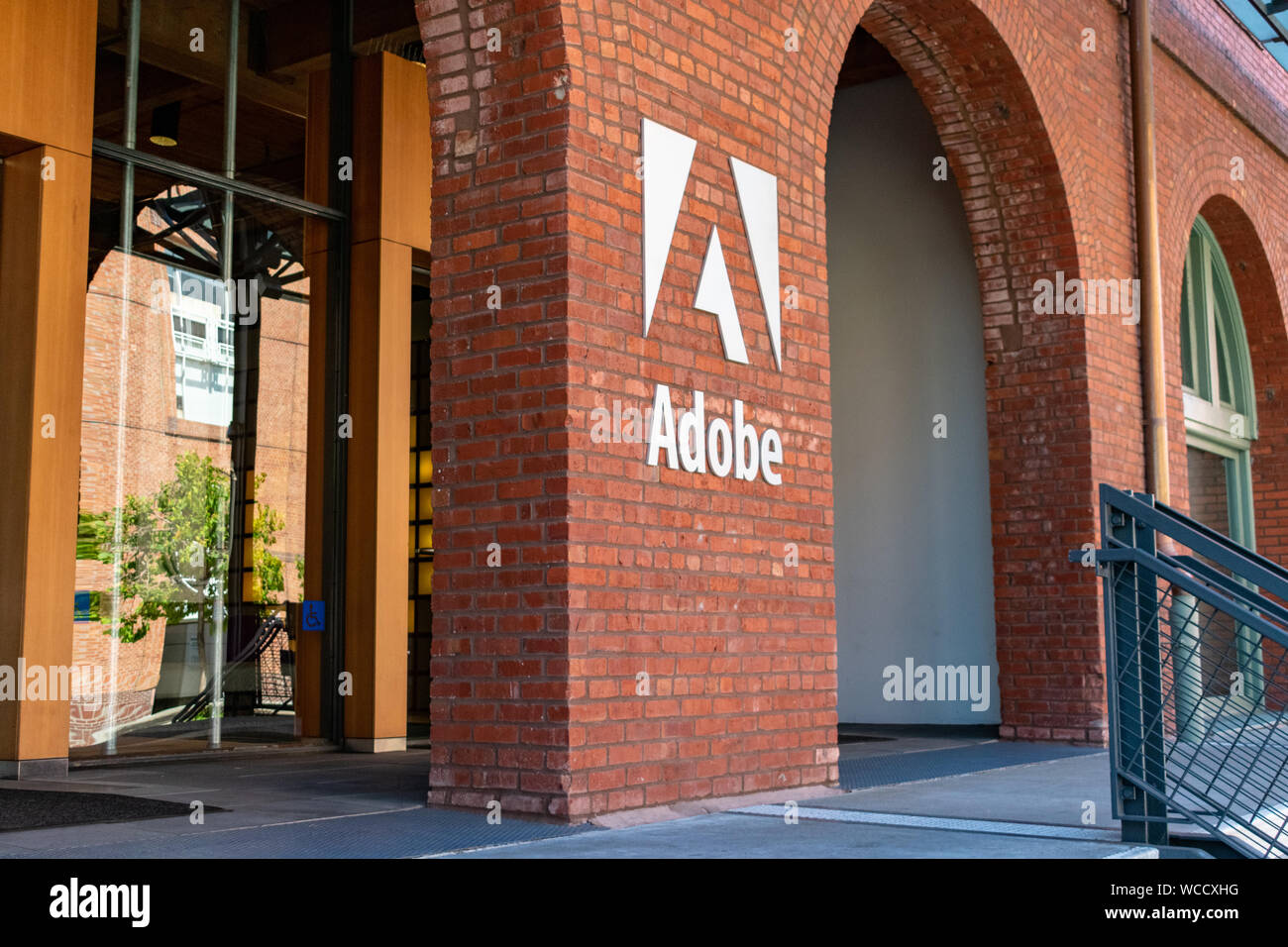 Adobe Logo auf dem Backstein Büro Fassade der computer software unternehmen, das sich auf die Erstellung von Multimedia- und Kreativität Software Produkte Stockfoto