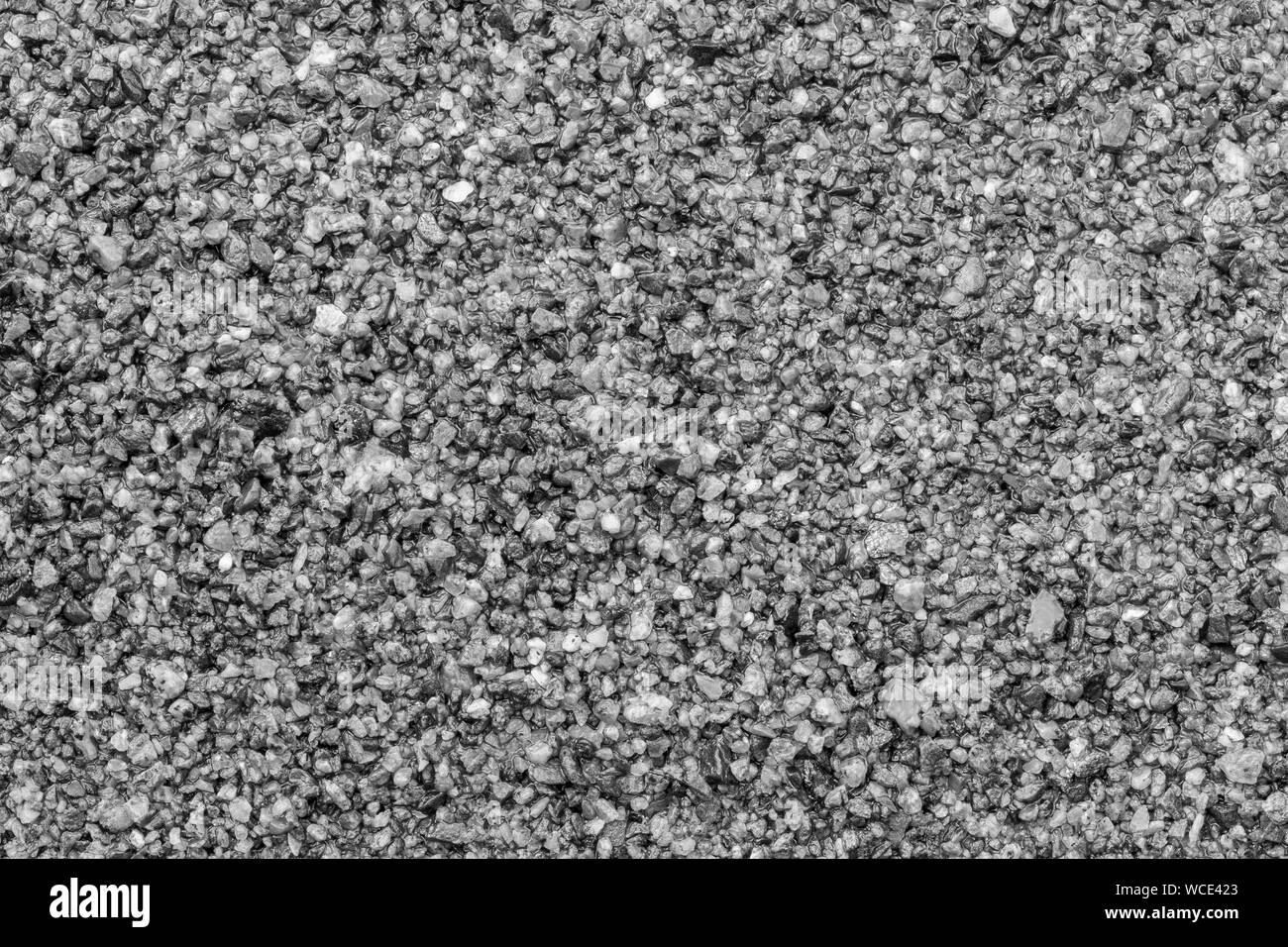 Makro Nahaufnahme von nassem Sand, gesehen von oben in Schwarz und Weiß. Hochauflösende full frame strukturierten Hintergrund. Stockfoto