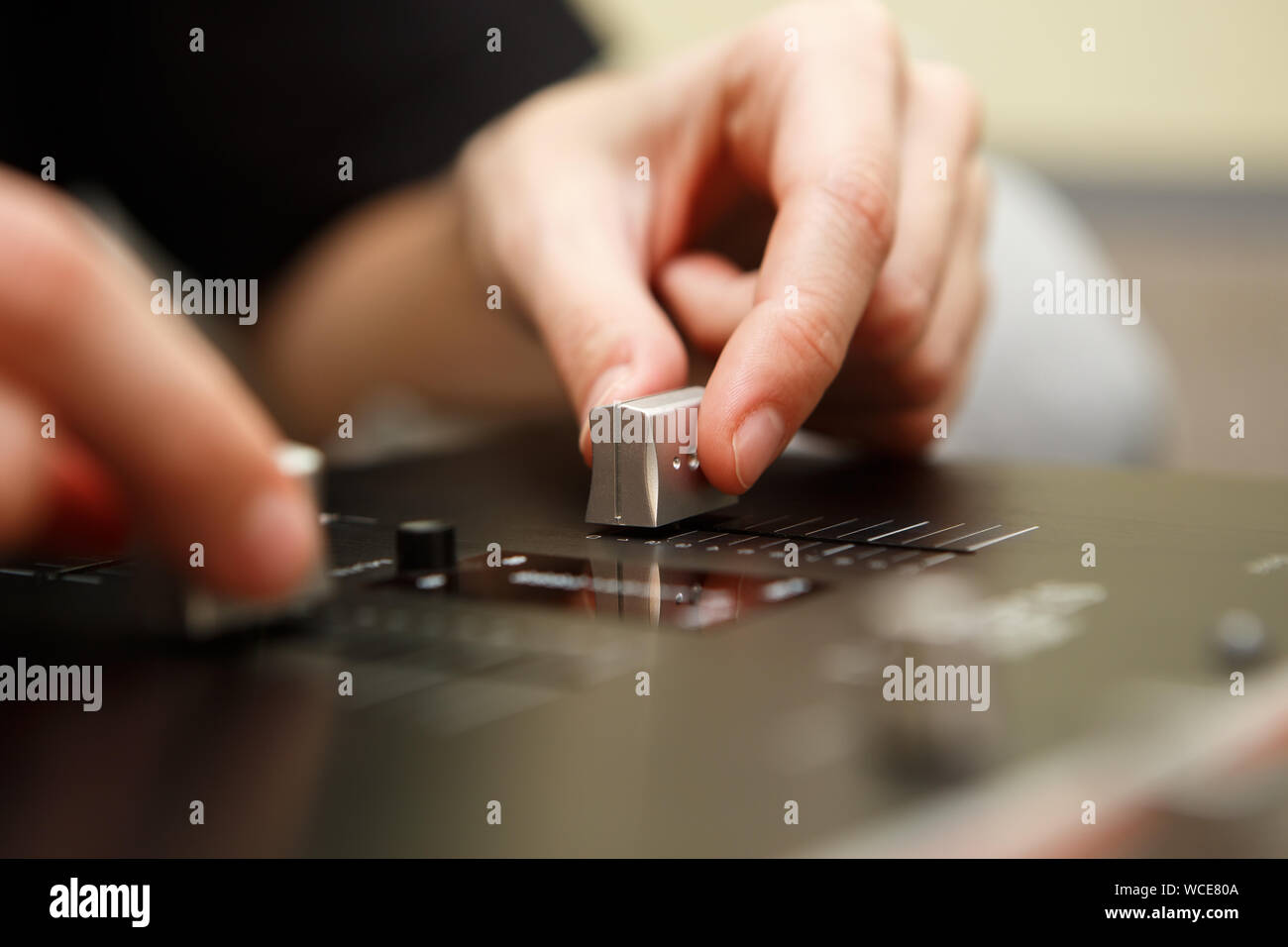 Hip hop dj Girl mischt musikalische Titel mit Professional Sound Mixer Panel in Sound Recording Studio. Weibliche disc jockey Hände auf Controller Device Trennvorrichtungseinstellungen vornehmen Stockfoto
