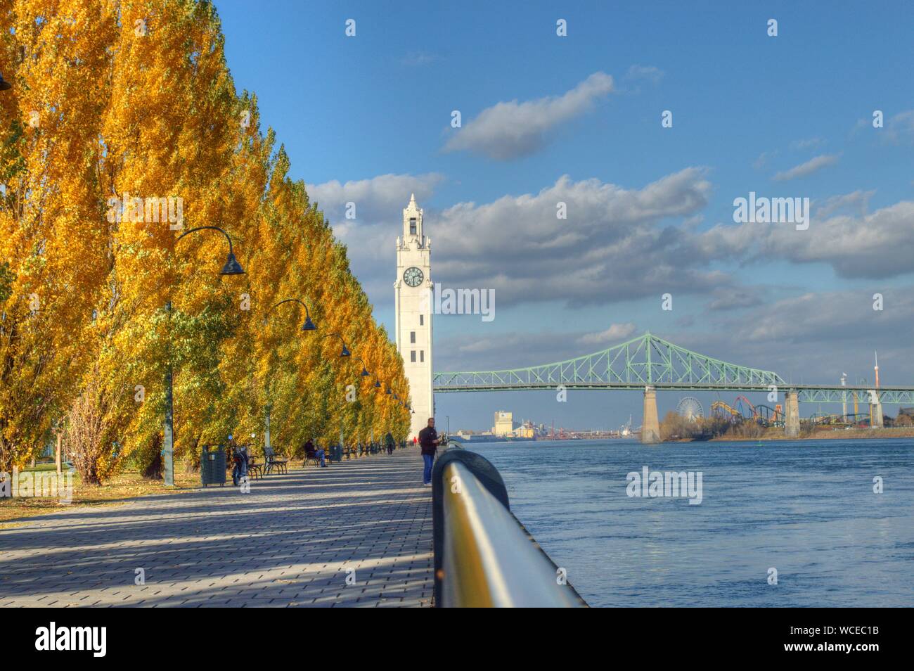 Bäume im Herbst und Uhrturm von Brücke über St Lawrence River Stockfoto