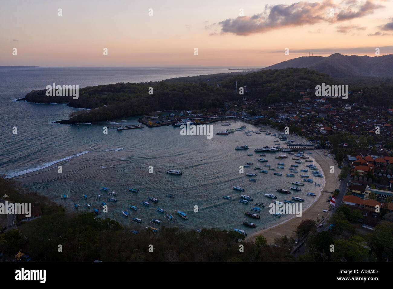 Luftaufnahme der Sonnenuntergang über der atemberaubenden Padangbai Bucht, Strand und Fährhafen in Bali, Indonesien Stockfoto