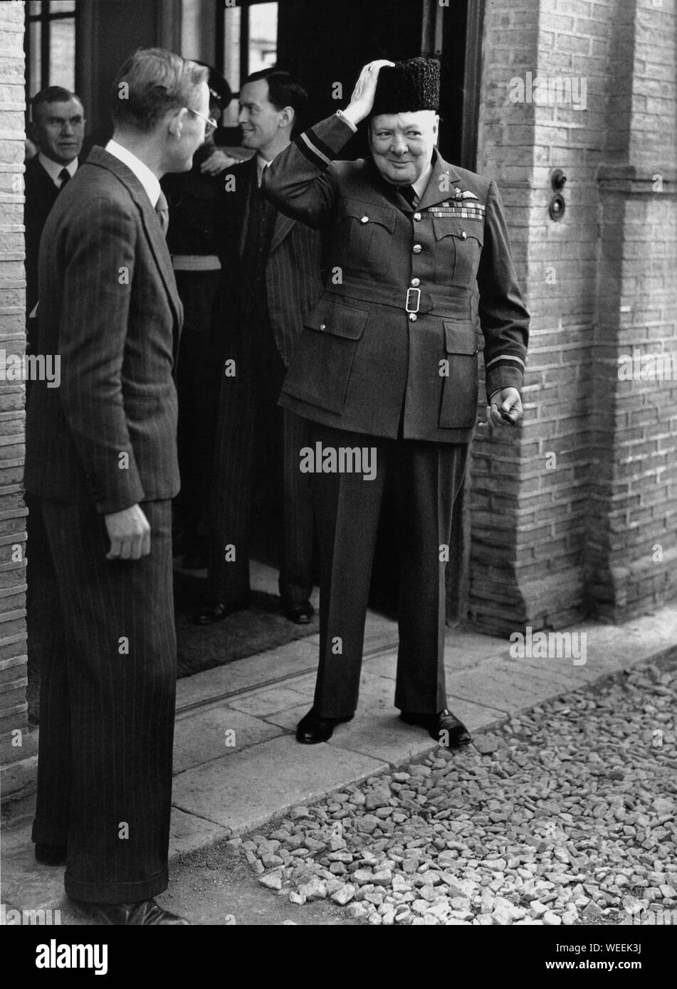 Churchill verlässt die britische Legation in Teheran, trägt einen Astrachan Lämmer Wollhut und seine Uniform als Air Commodore von RAF 615 Squadron. November 1943 Stockfoto