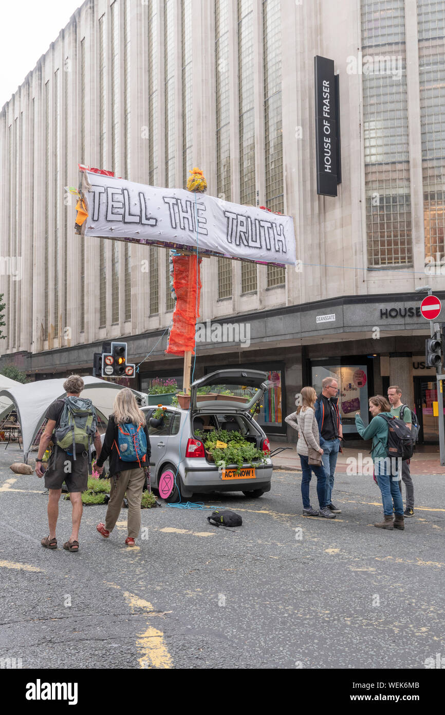 Klima protest Gruppe Aussterben Rebellion hält Protest Sperrung einer der belebtesten Straßen Manchesters Stadtzentrum - Deansgate. Stockfoto