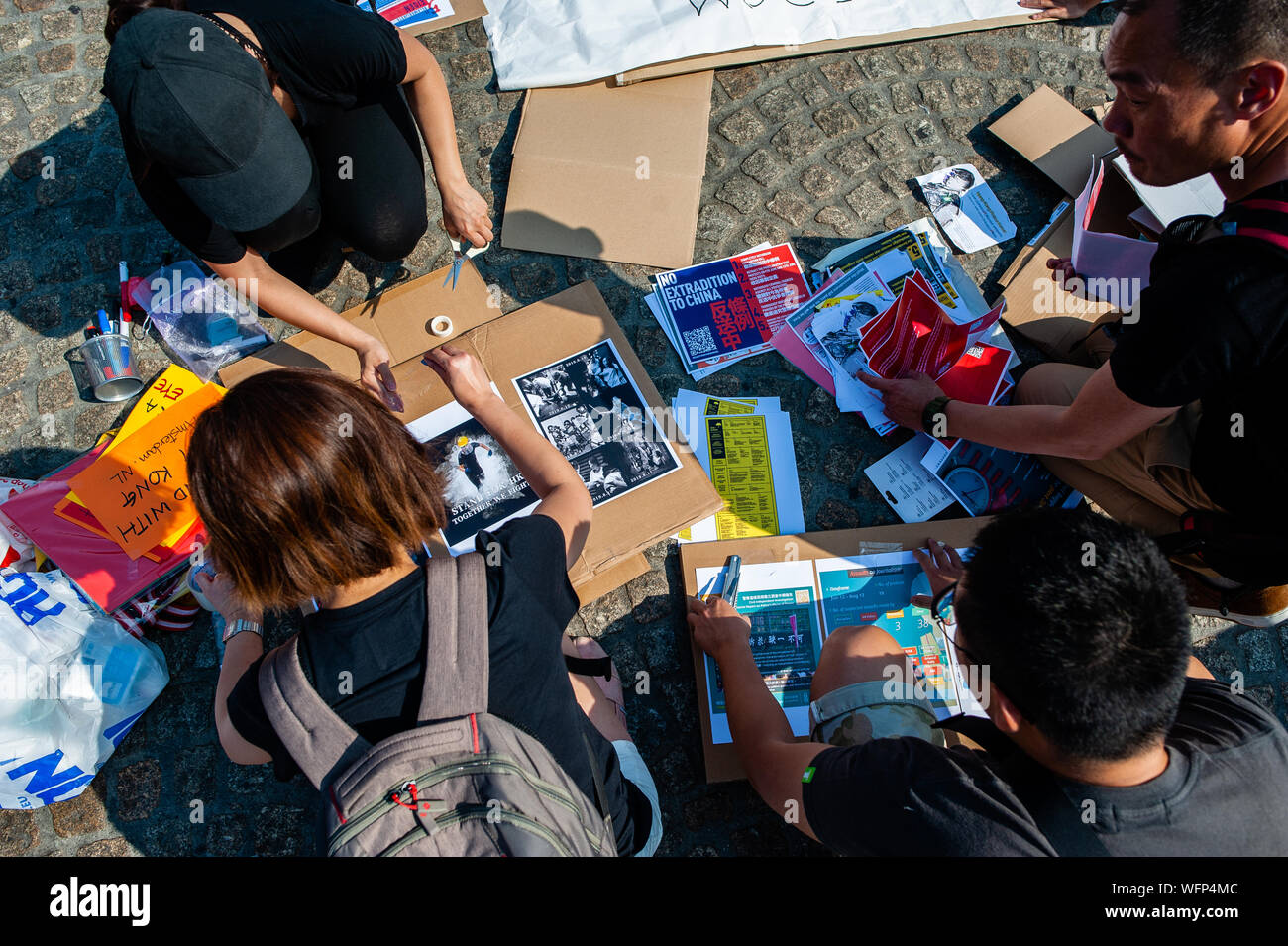 Eine Gruppe von Leuten, die Schilder, die während der Demonstration. Menschen versammelt, tragen schwarze Kleidung am Dam Platz protestieren in Solidarität mit den Menschen in Hongkong. Proteste wurden für zwei Monate, über einen jetzt - verschobene Auslieferung Rechnung, aber Nachfragen haben zu Forderungen nach Demokratie und politische Reformen erweitert. Die Regierung von Hongkong hat zu keinen der 5 Forderungen der Menschen in Hongkong reagiert. Stockfoto