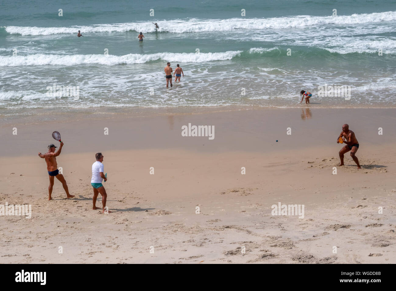 Rio de Janeiro, Brasilien - 01 September, 2019: Frescobol Spieler und Strandurlauber Spaß an einem Sonntag Morgen am Strand Praia do Diabo, Rio de Janeiro. Stockfoto