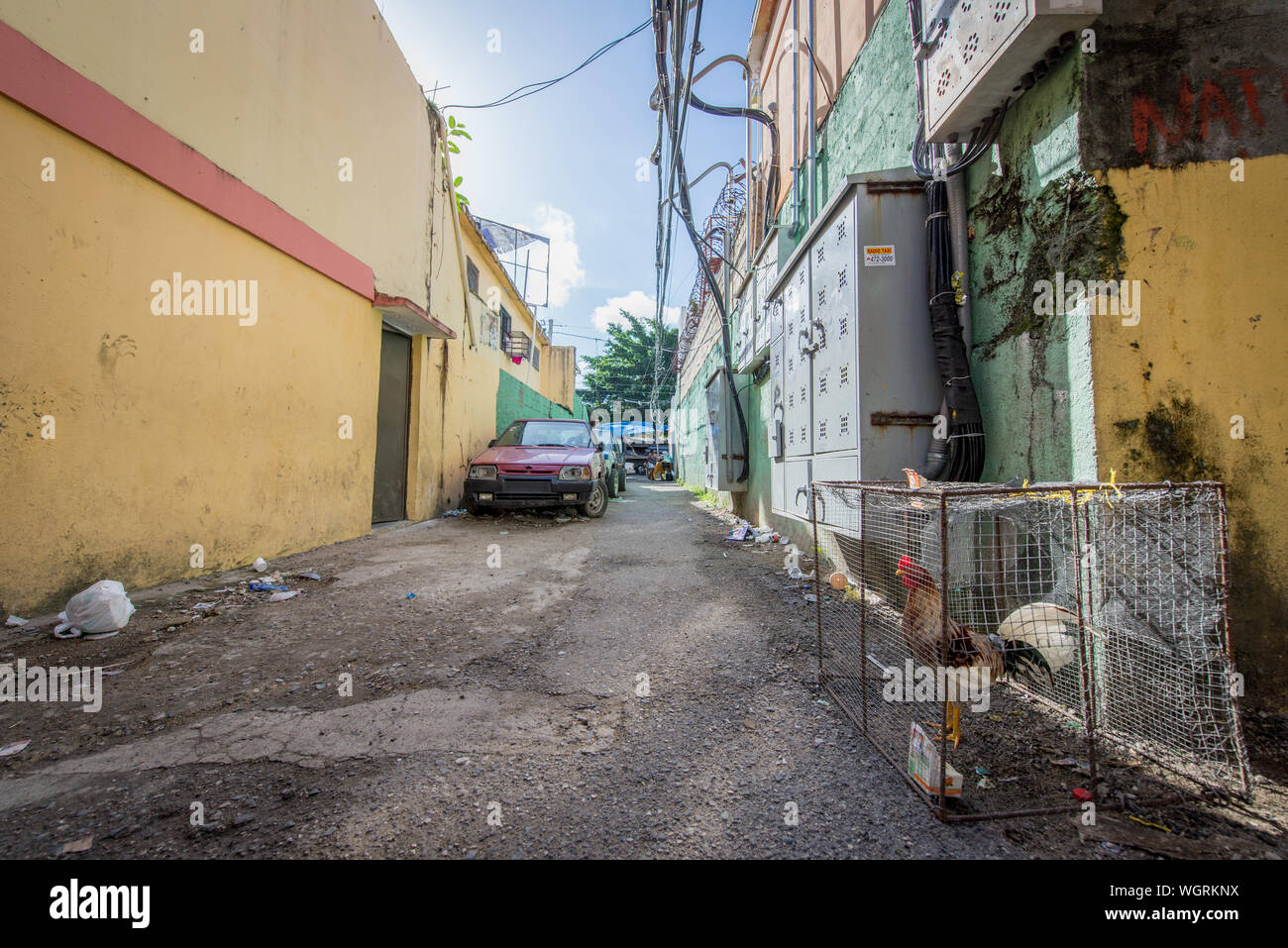Gasse zu Autos mit Müll und ein Huhn gesperrt in der Dominikanischen Republik Stockfoto