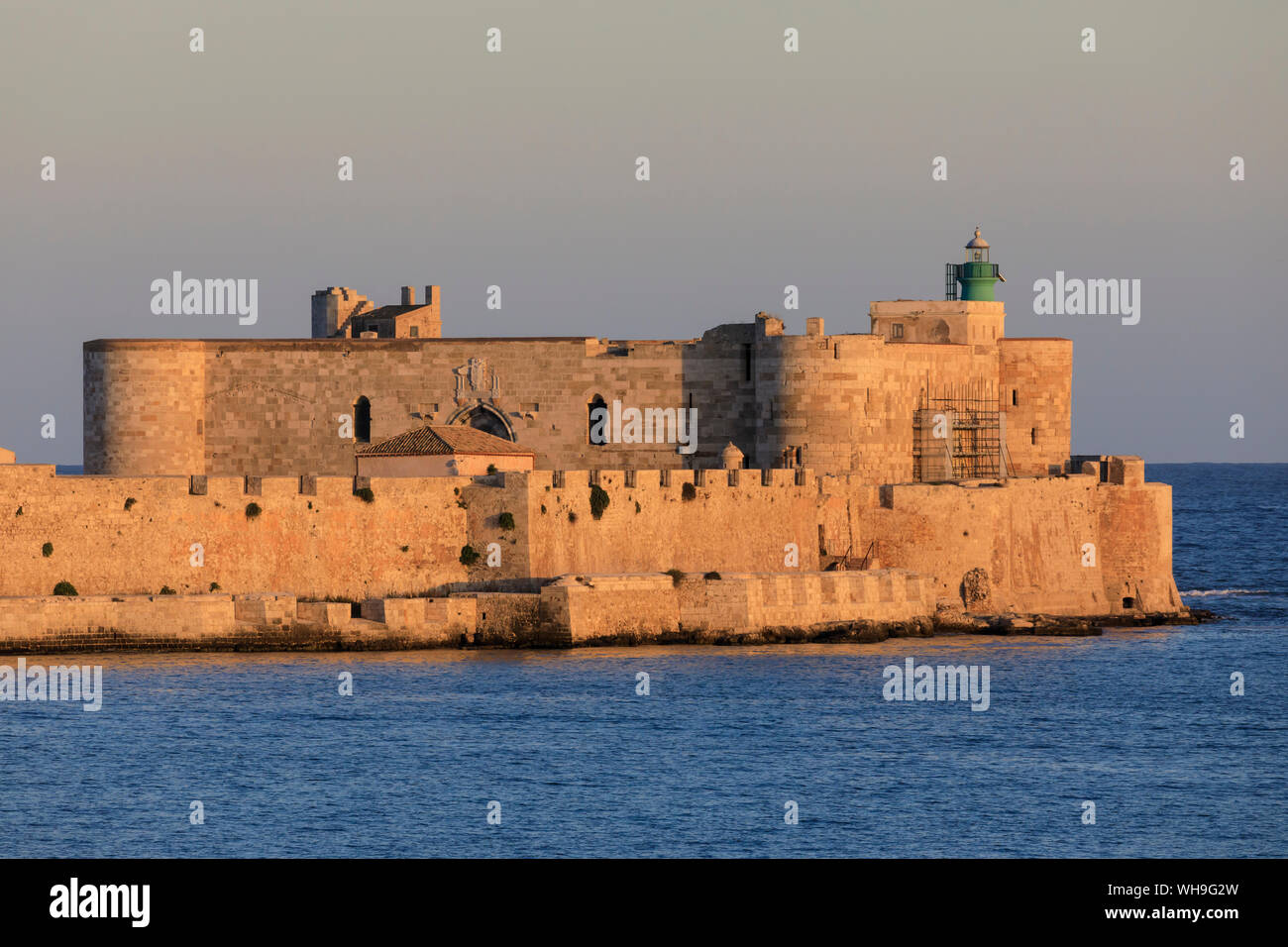 Sonnenuntergang leuchtet Maniace Schloss, Ortigia (Ortygia), vom Meer, Syrakus (Siracusa), Weltkulturerbe der UNESCO, Sizilien, Italien, Mittelmeer Stockfoto