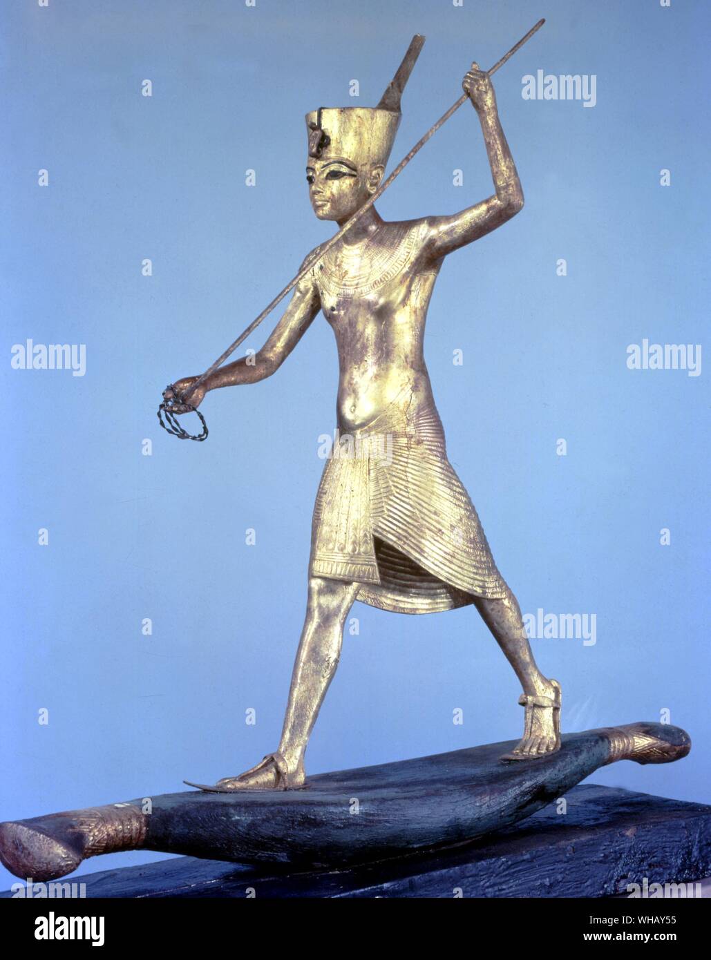 Tutanchamun auf einem Papyrus floss in die Haltung eines harpooner. Eine Der funerarial Objekte verwendet, um die Mystischen Wallfahrten während der Beerdigung zu evozieren. Vergoldetem Holz. Tukankhamen, von Christiane Desroches Noblecourt.. Die Schatzkammer im Grab des Tutanchamun enthielt Zwanzig - Zwei schwarz lackierte Holz- Schatullen, von denen jede eine oder mehrere hölzerne Statuen, die den Pharao oder eine Reihe von Gottheiten aus der ägyptischen Pantheon enthalten. Alle Zahlen im schwarzen Laubhütten enthalten sind, um eine rechteckige Grundfläche festgesetzt und zum Zeitpunkt ihrer Entdeckung wurden in einem Leinentuch datable gewickelt Stockfoto