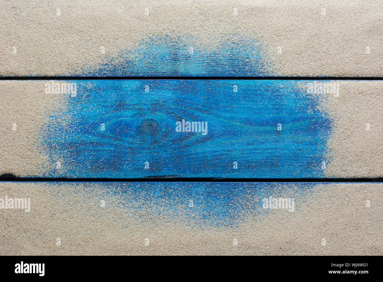 Sommer Grenze mit gelbem Sand auf Blau Holz- Hintergrund Stockfoto