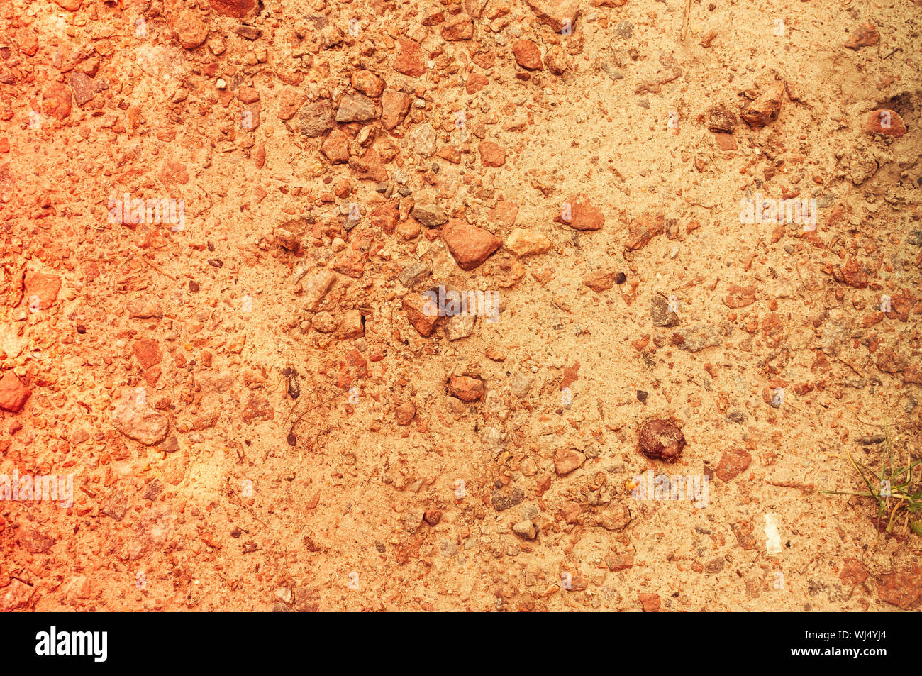 Die Metallabdeckung des Abwasserkanals Mannloch ist mit Sand bedeckt. Warme Tonung und kopieren Raum Stockfoto
